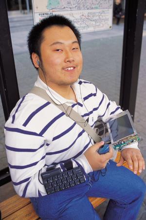 Posing for a magazine photographer while wearing the wearable computer. Photo courtesy of I Love PC.